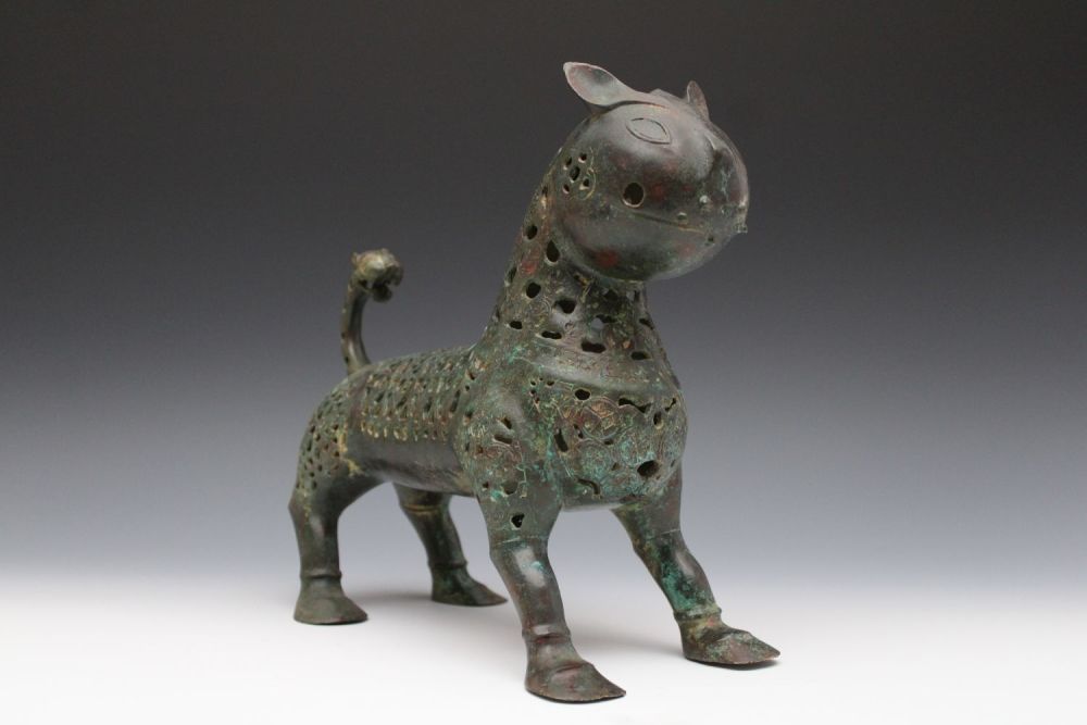 Lot 8: An Islamic Bronze Lion with Intricate Openwork.