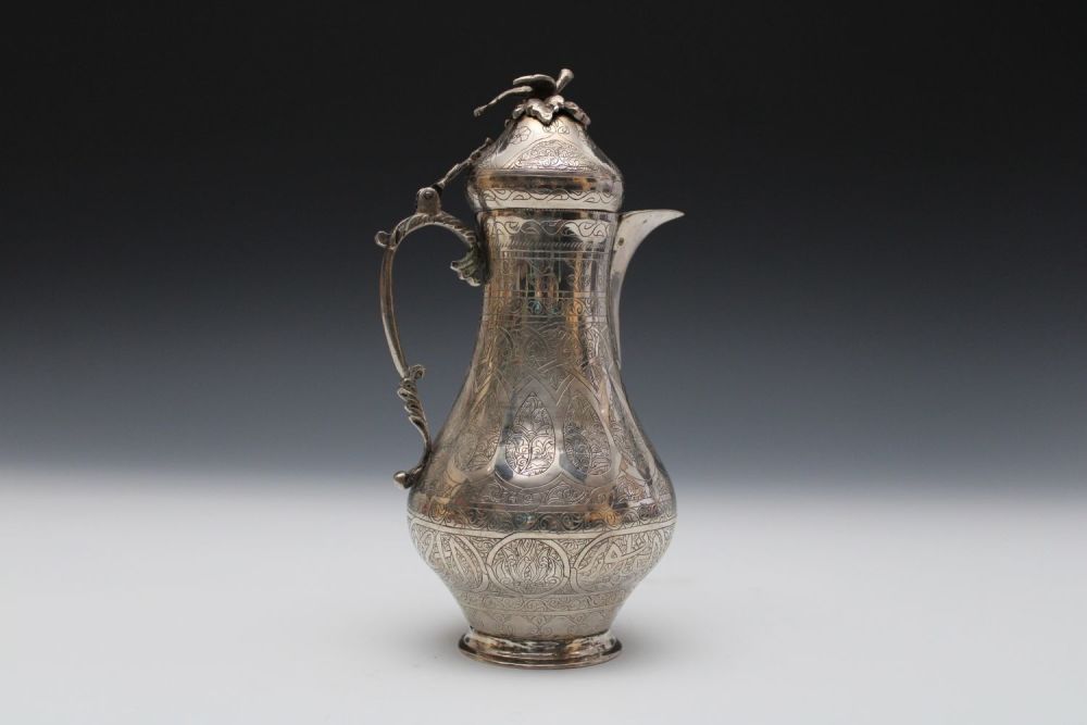 Lot 9: An Islamic Silver Coffee Pot Decorated with Islamic...