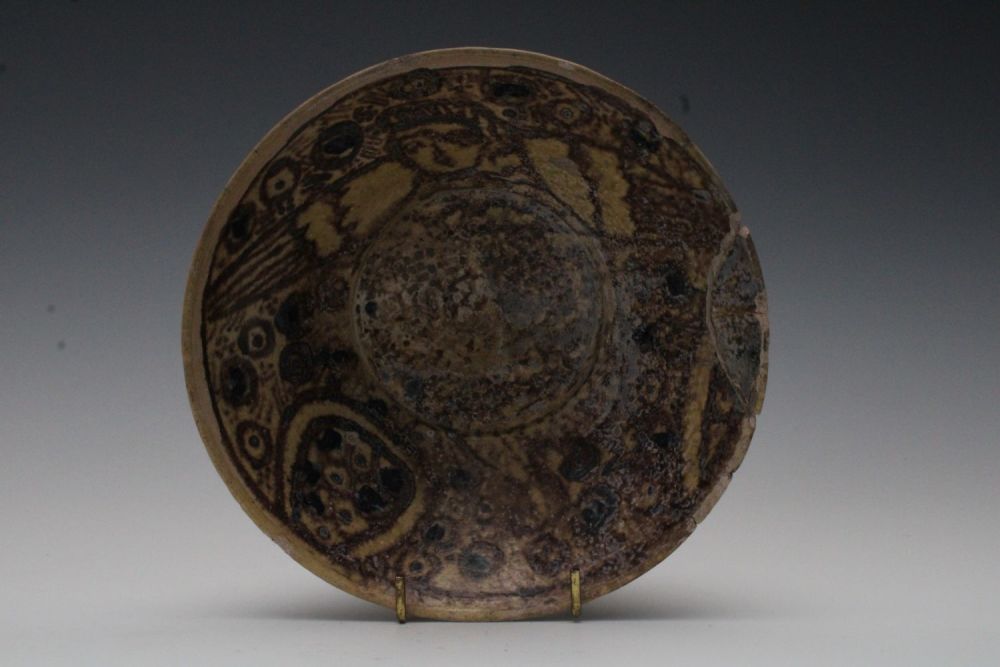 Lot 40: An Islamic Yellow and Brown Glazed Dish with...