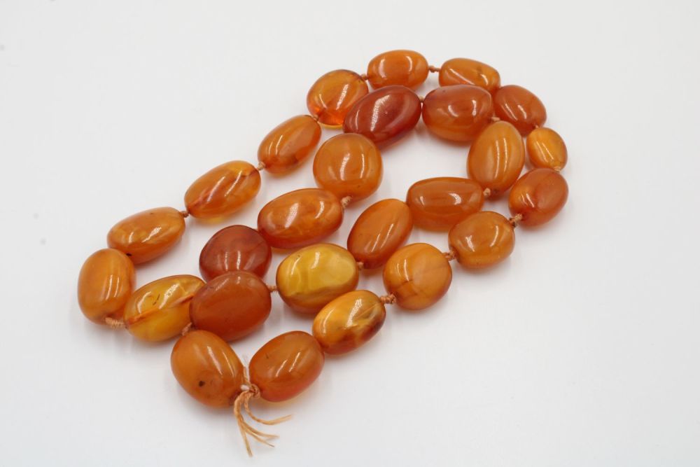 Lot 130: A Large Necklace of Amber Beads.