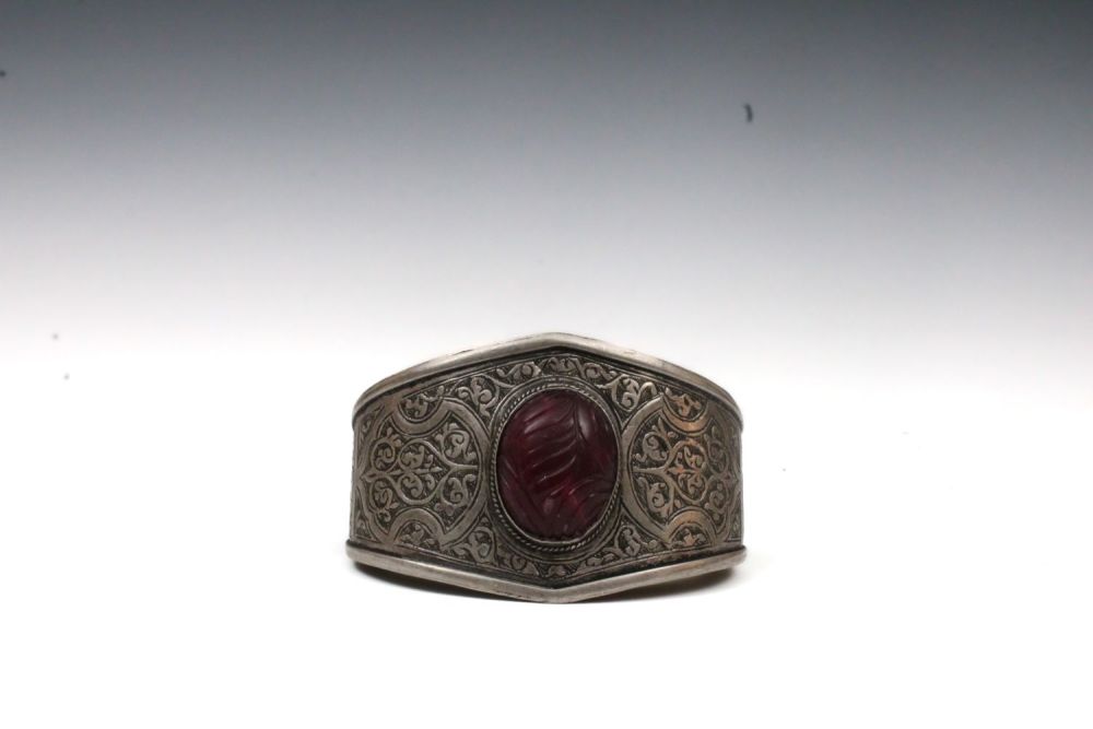 Lot 135: An Afghan Turkmen Silver Bangle with a Dyed...