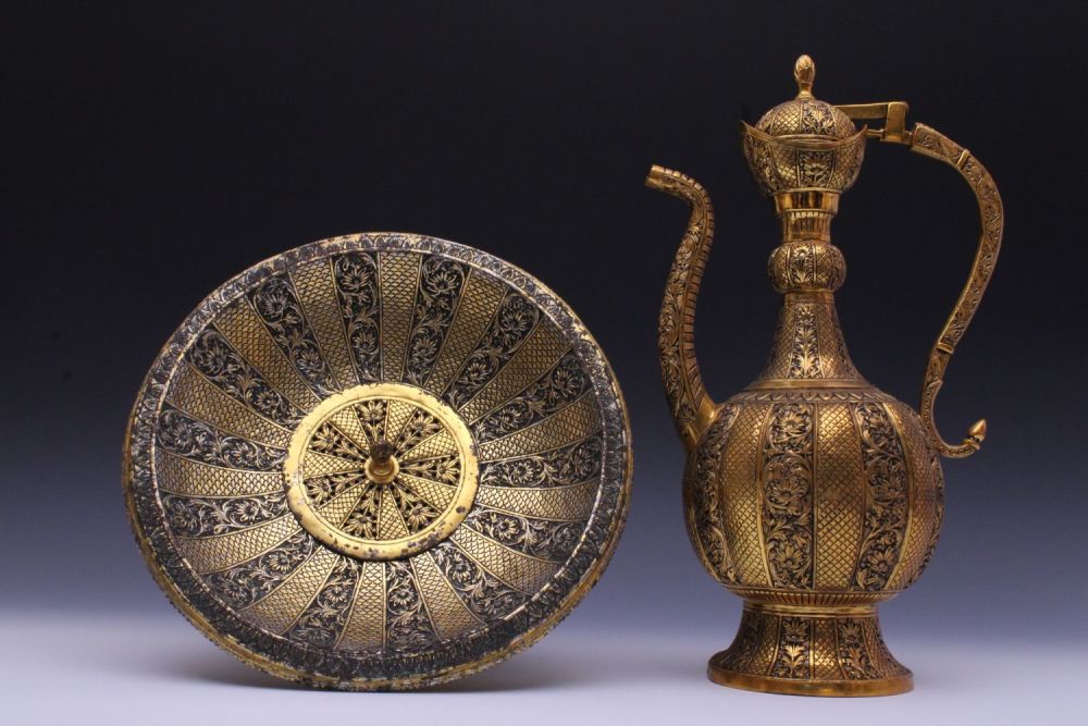 Lot 151: An Indian Brass Aftaba Ewer and Basin with...