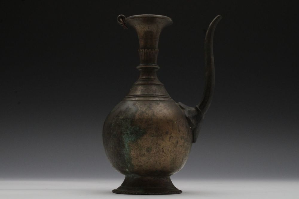 Lot 160: A Nepalese Brass Ewer with a Peacock Finial...