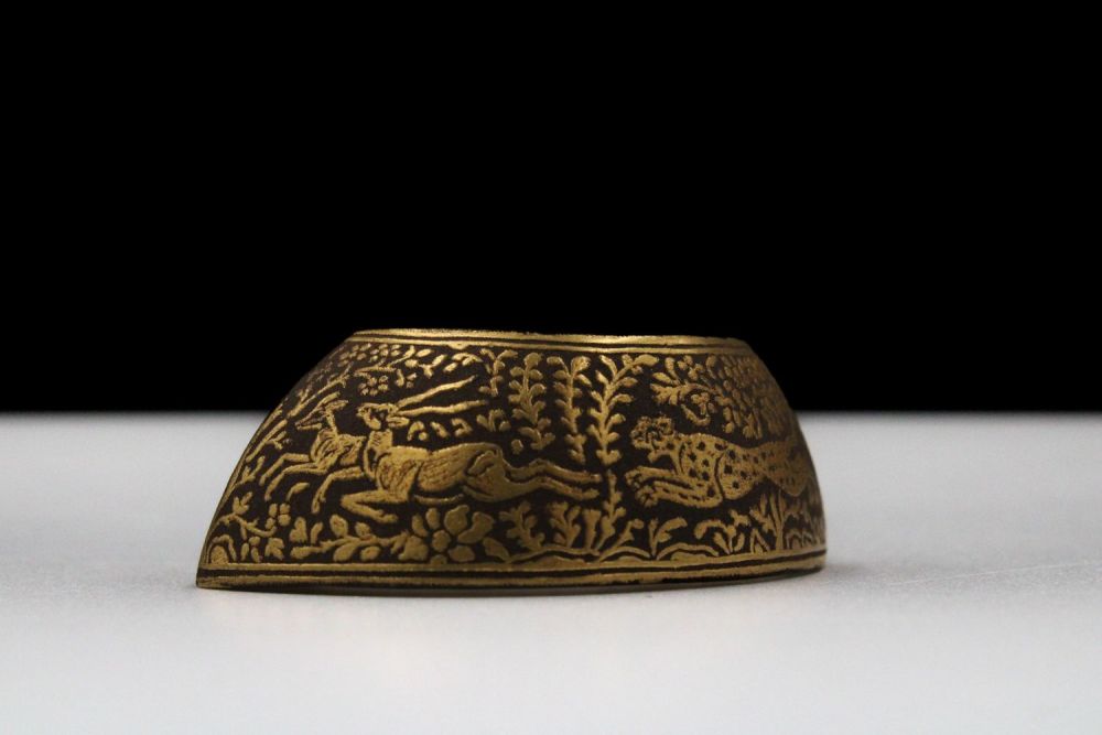 Lot 169: An Indian Iron Thumb Ring with Gold Inlay.
