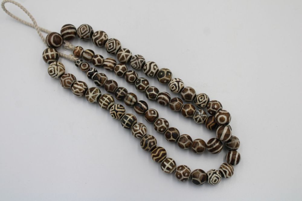 Lot 178: A Tibetan Pumtek Petrified Wood Stone Dzi Beads...