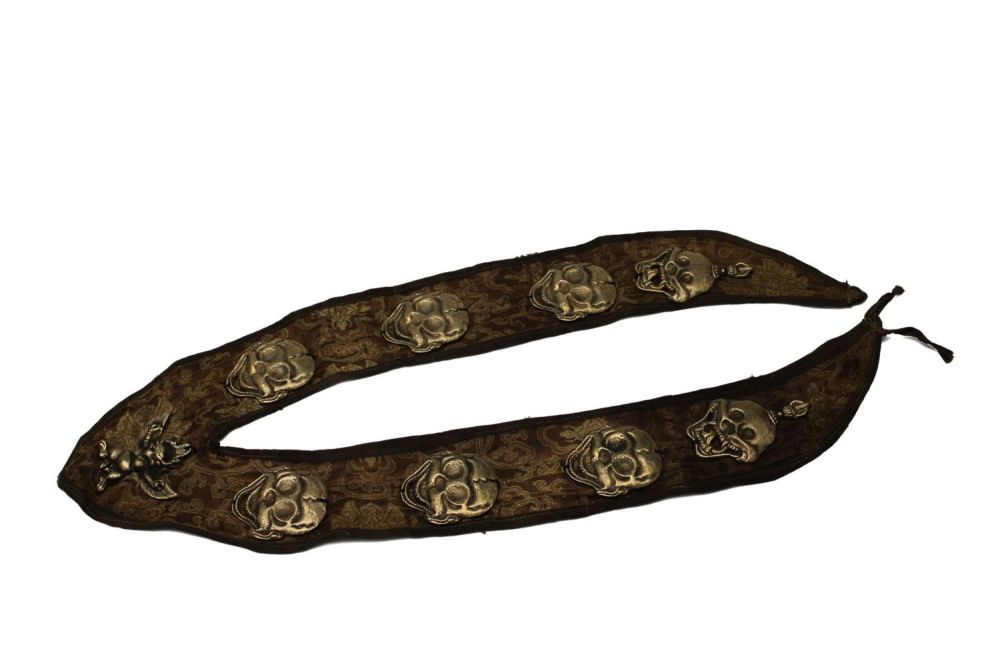 Lot 179: A Tibetan Brass Skull Amulet Necklace.