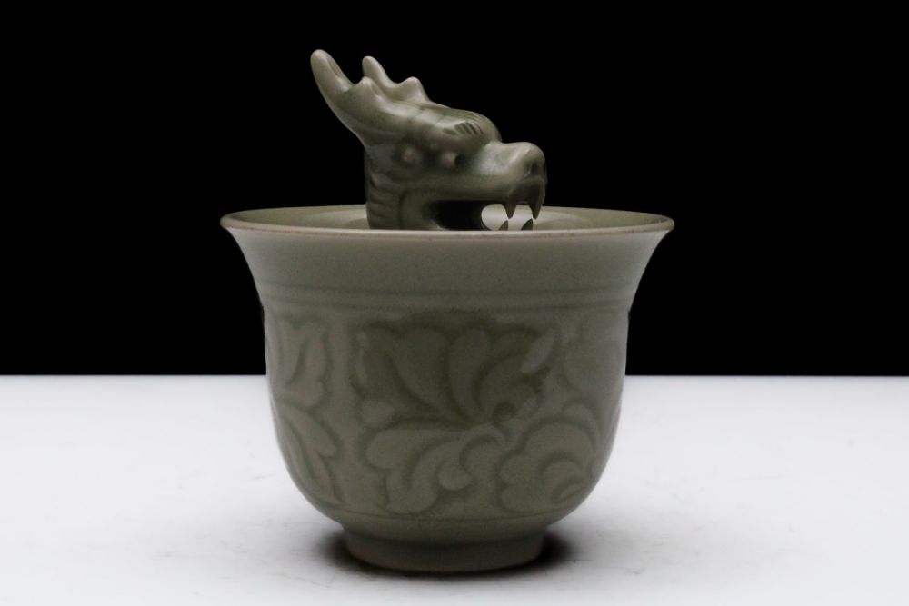 Lot 321: A Chinese Celadon Porcelain Vessel with a Dragon...