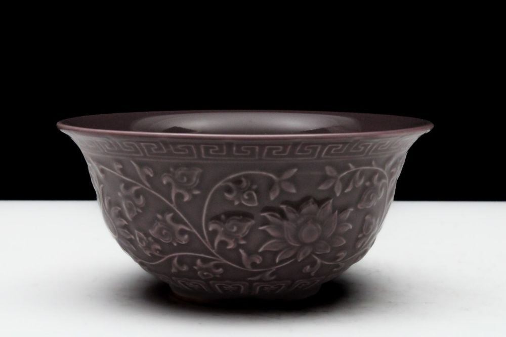 Lot 323: A Chinese Porcelain Aubergine Bowl with Floral Patterns.