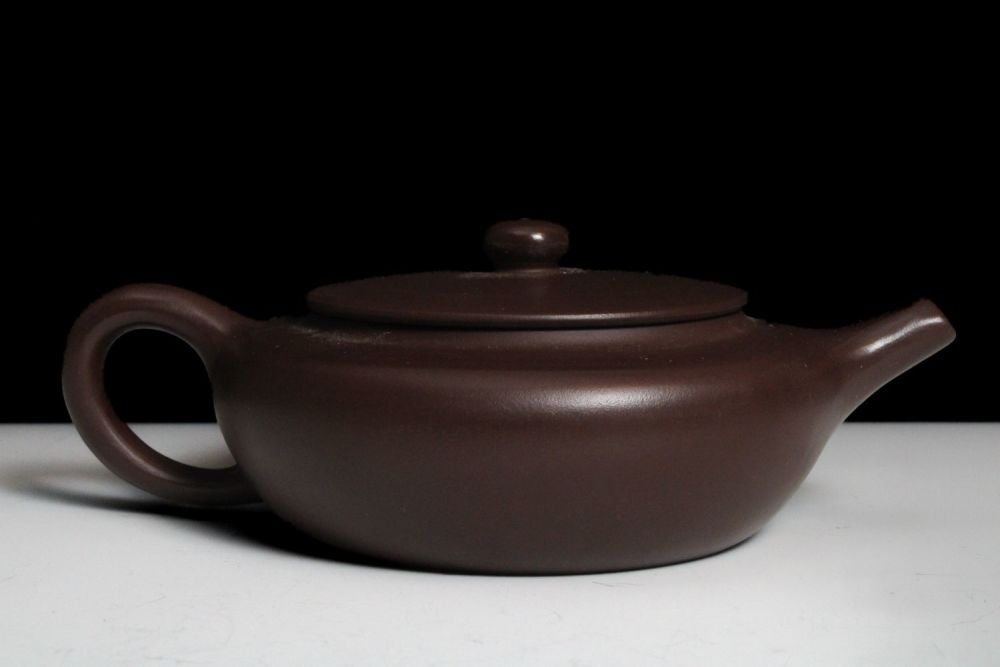 Lot 346: A Chinese Yixing Zisha Flat Teapot with Character...