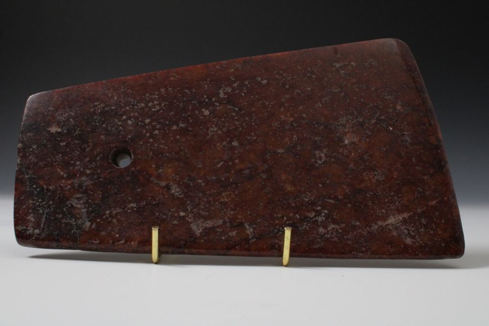Lot 353: A Chinese Red Hardstone Ritual Axe.