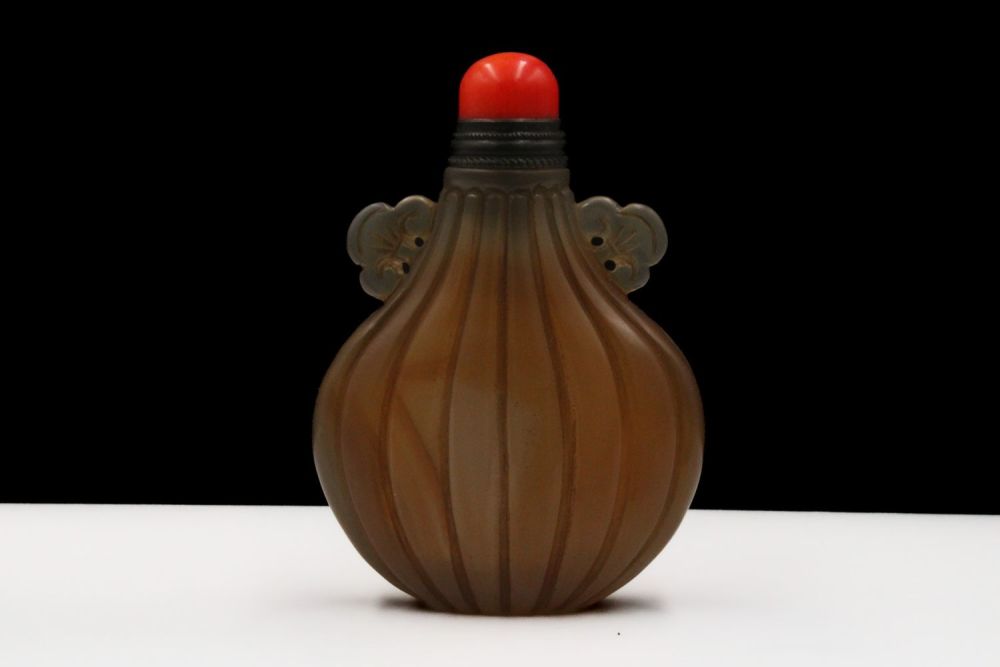 Lot 377: A Chinese Agate Uniquely Carved Snuff Bottle.