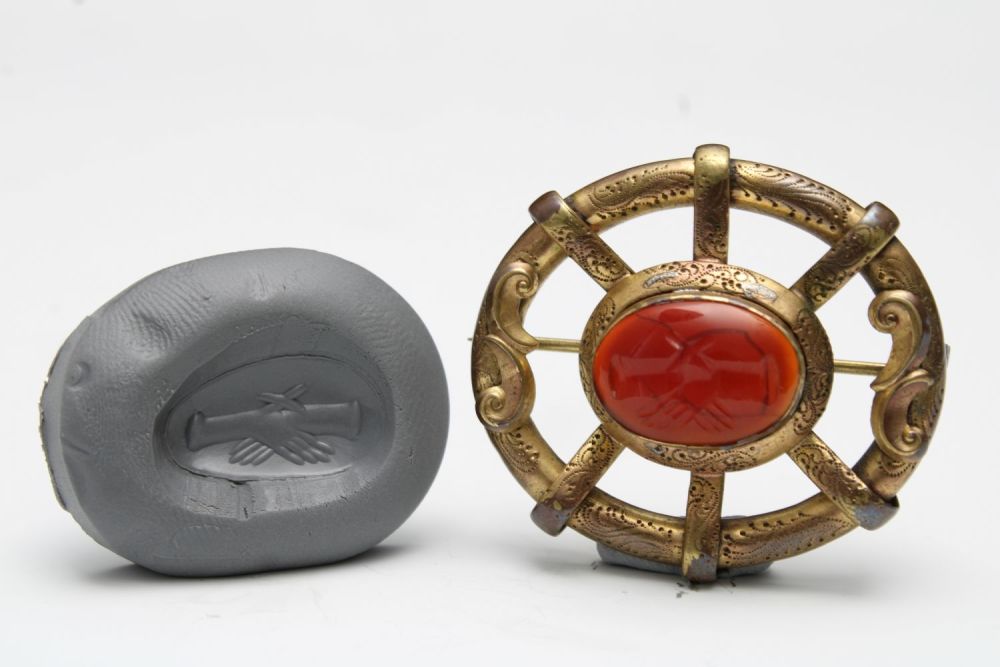 Lot 436: A European Medieval Brooch with a Carnelian Engraved...