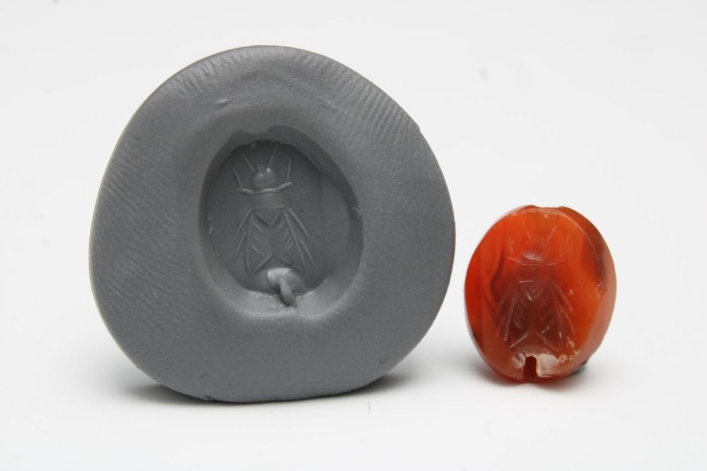 Lot 437: A Greek Red Agate Scarab Depicting a Fly.