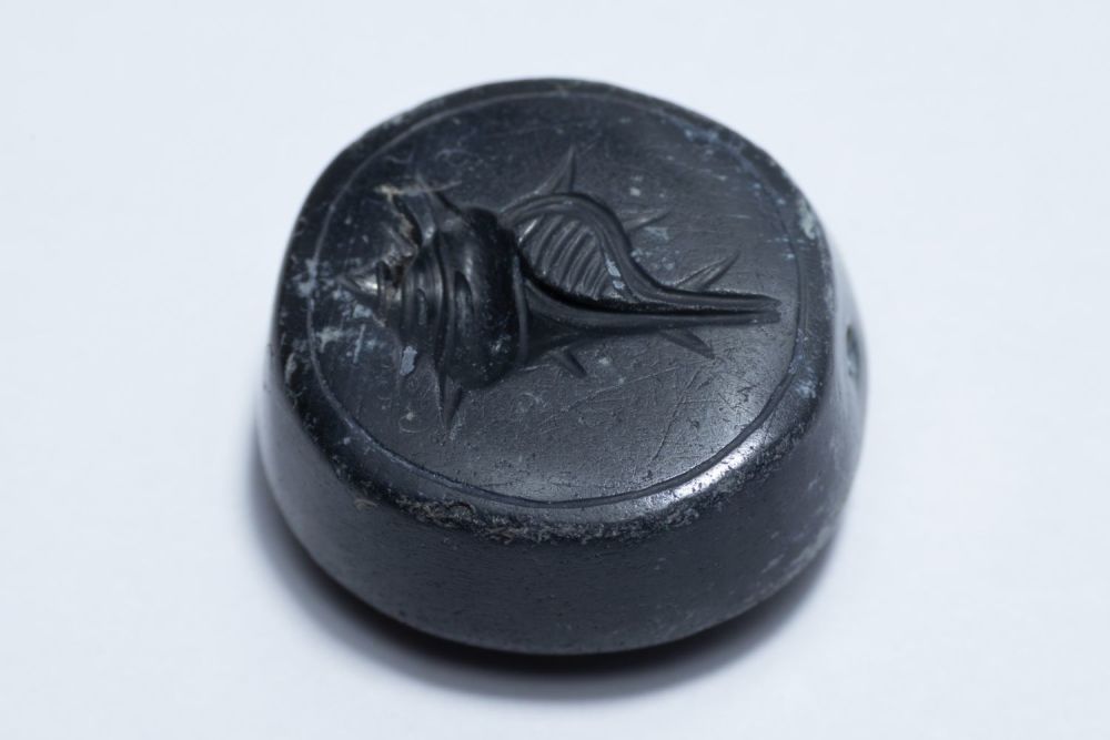 Lot 171: A Greek Carnelian Scarab Depicting a Sea Conch...