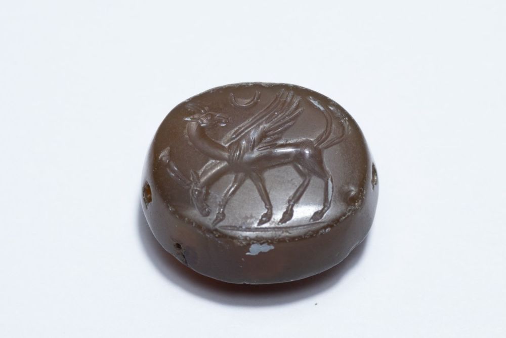 Lot 174: A Greco-Persian Dark Red Agate Scarab Depicting Two...