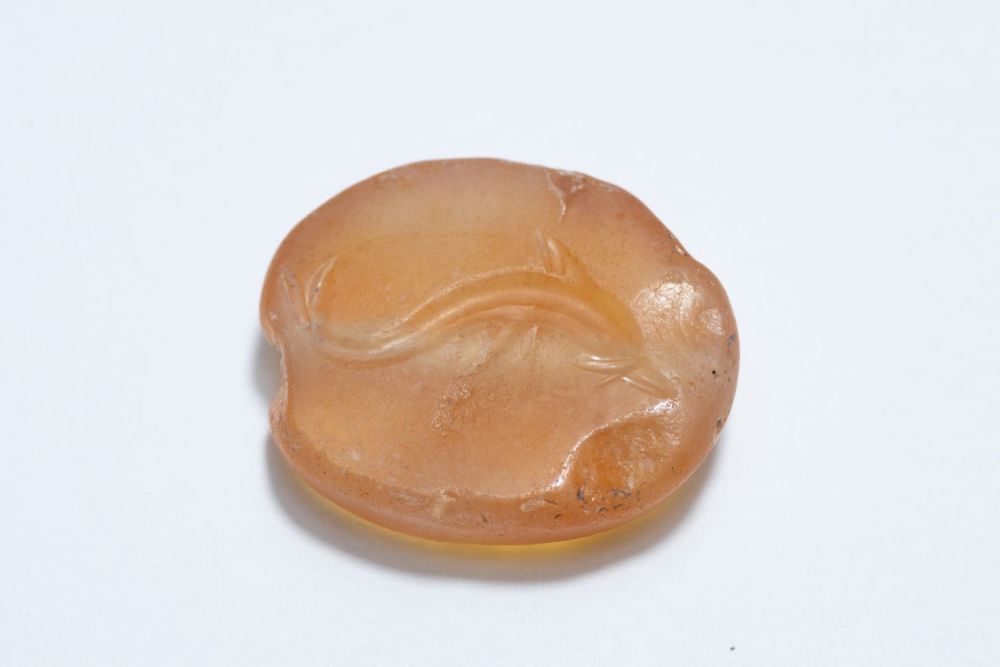 Lot 175: A Greek Carnelian Scarab Gem Depicting a Dolphin.