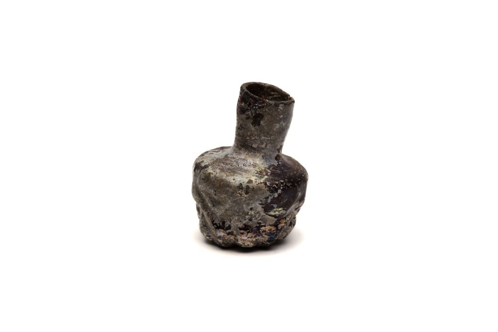 Lot 184: An Islamic Dark Glass Bottle with Lovely Patina...