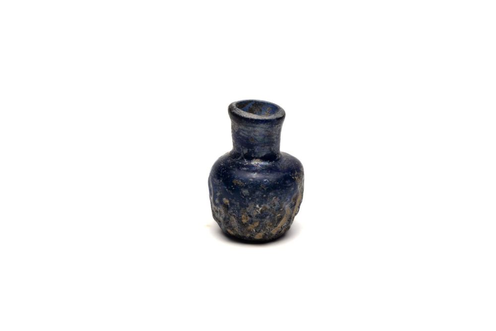 Lot 188: An Islamic Small Blue Moulded Glass with Patina...
