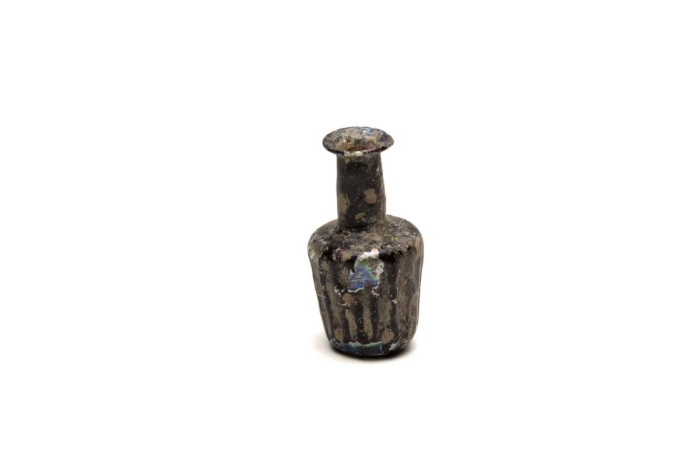 Lot 191: An Islamic Light Green Glass Moulded Bottle with...