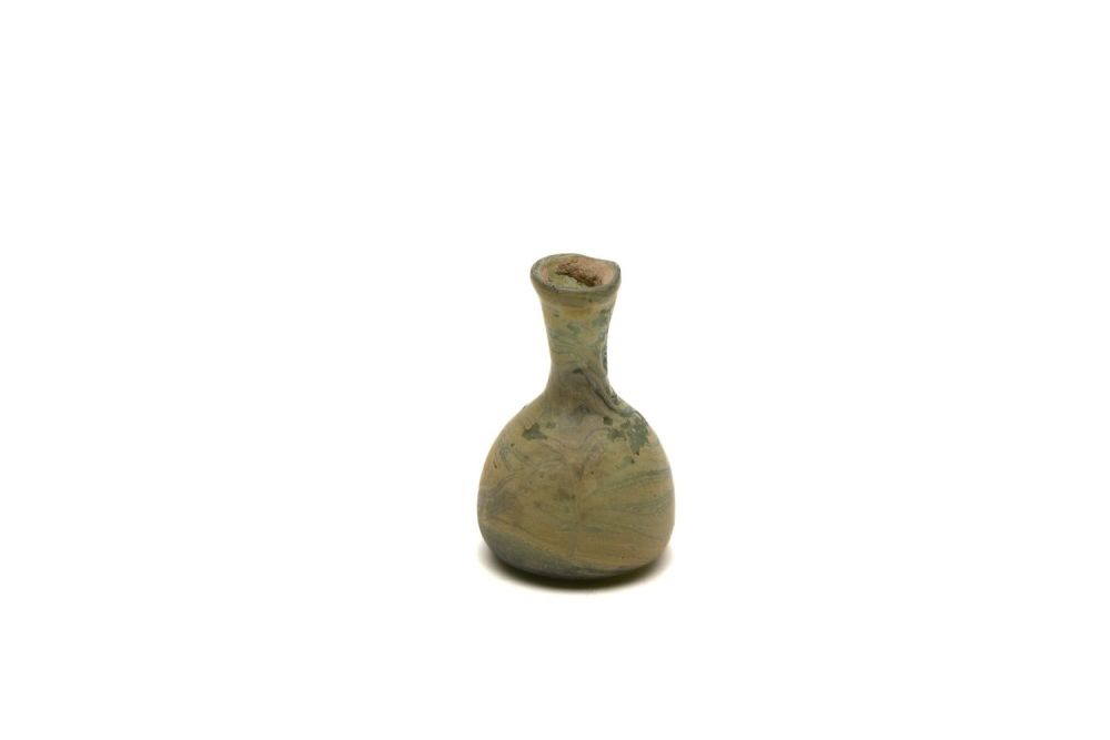Lot 192: An Islamic Green Glass Small Bottle with Patina...