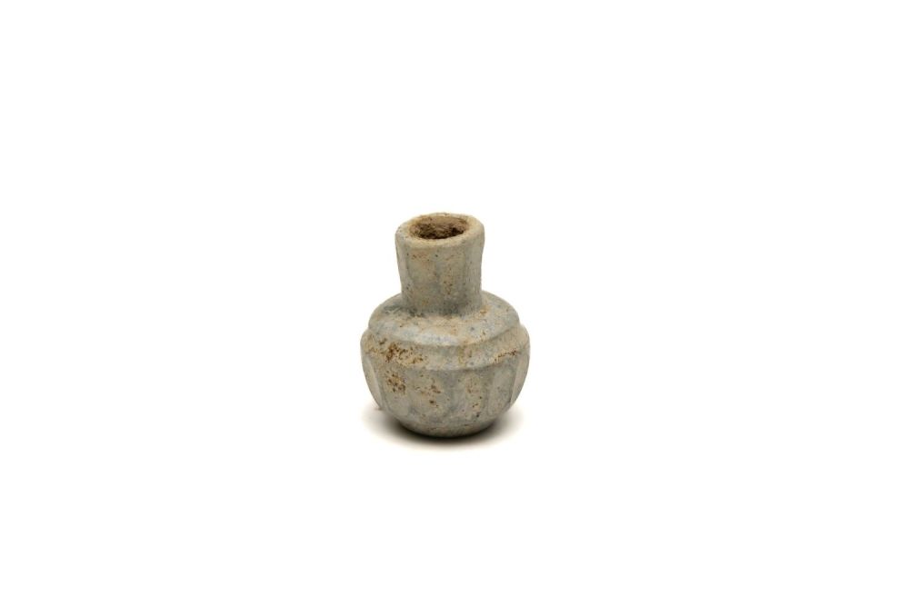 Lot 193: A Sassanian Light Green Cut Glass Small Bottle...