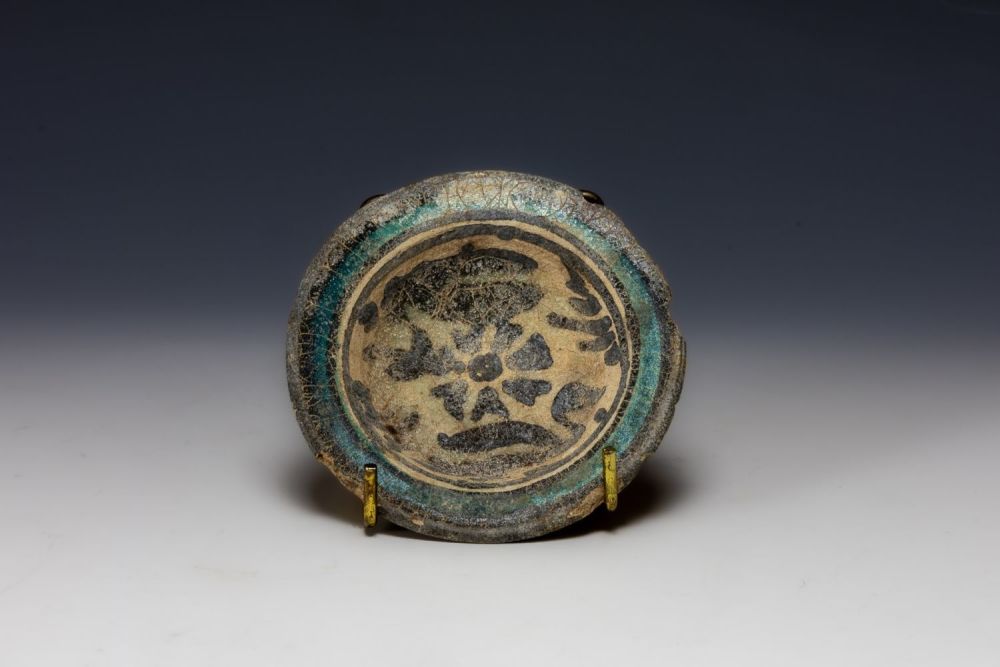 Lot 201: A Raqqa Ceramic Well of Plates from the...