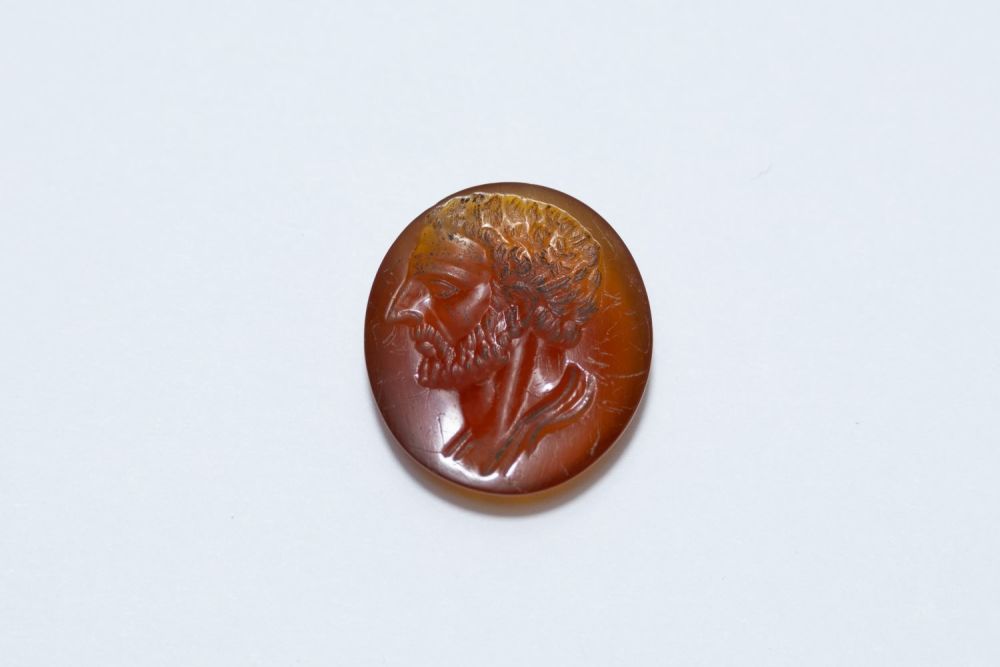 Lot 209: An Ancient Roman Red Agate Circular Stone Depicting...