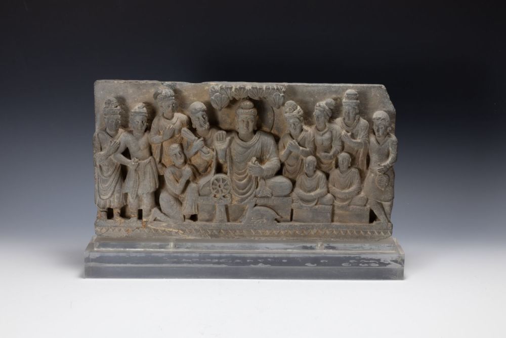 Lot 217: A Gandharan Grey Stone Frieze of a Buddha.