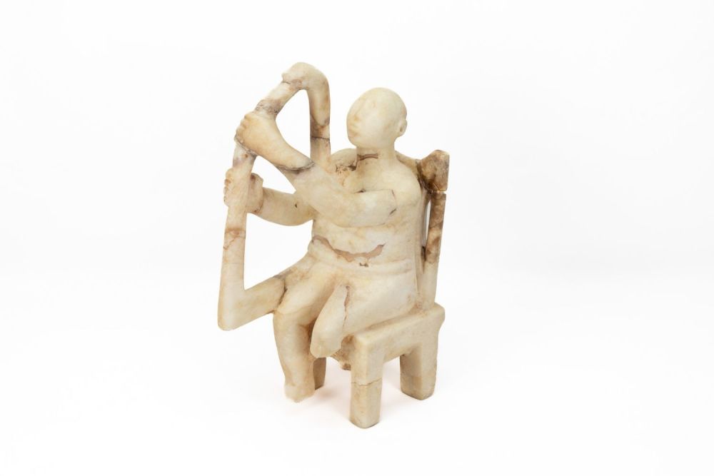 Lot 229: A White Marble Seated Musician in the Style...