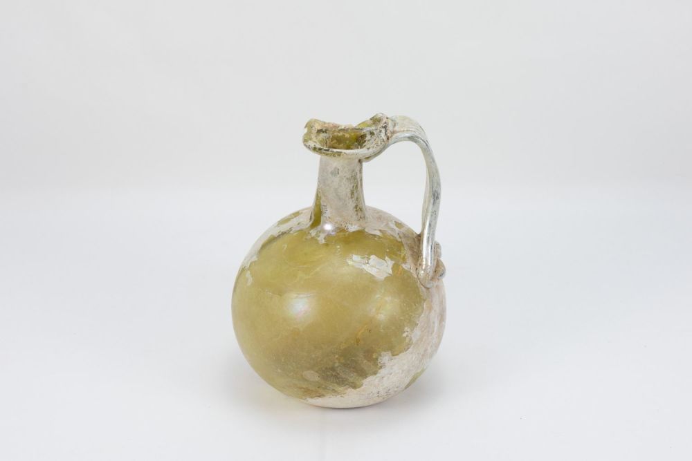 Lot 236: A Large Roman Internally Sectioned Flat Glass Bottle...