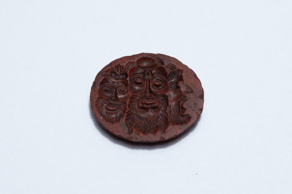 Lot 245: A Roman Bloodstone Intaglio of 3 Masks Theatre...