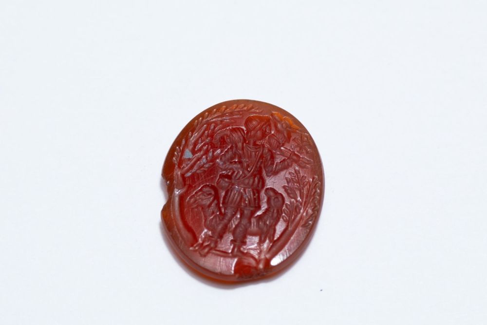 Lot 246: A Roman Carnelian Intaglio of a Shepherd Carrying...