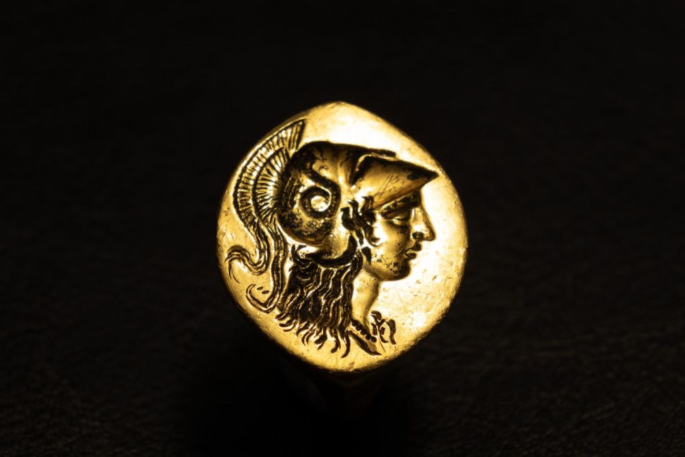 Lot 247: A God Signet Ring Decorated with Athena's Head,...