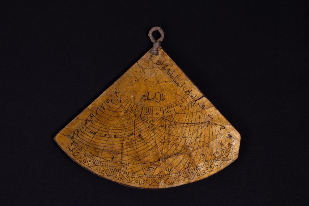 Lot 310: An Islamic Triangular Paper Mache Qibla Indicator and...