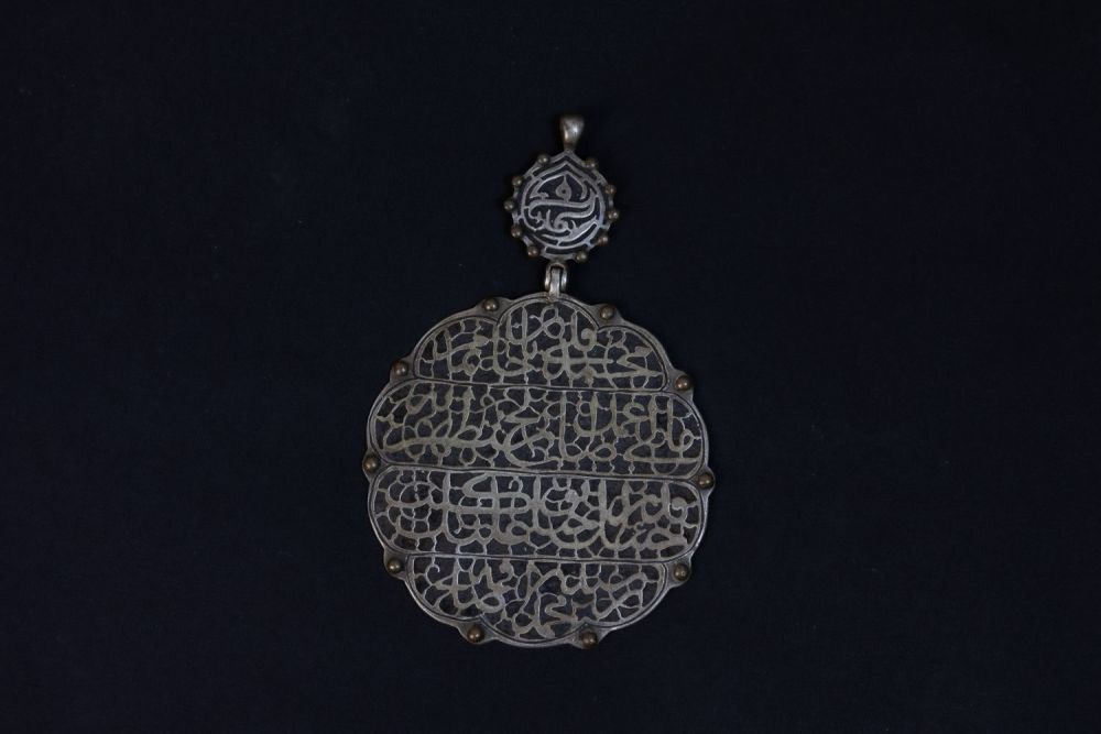 Lot 315: An Islamic Silver Pendant with Islamic Calligraphy.