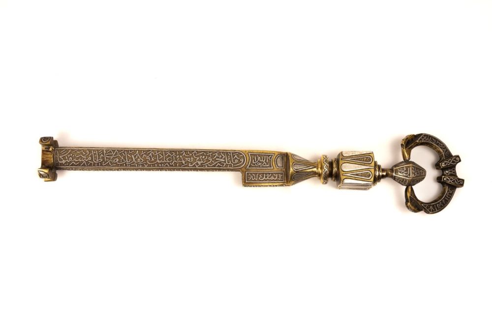 Lot 316: An Islamic Brass Kaaba Key with Silver Inlay...