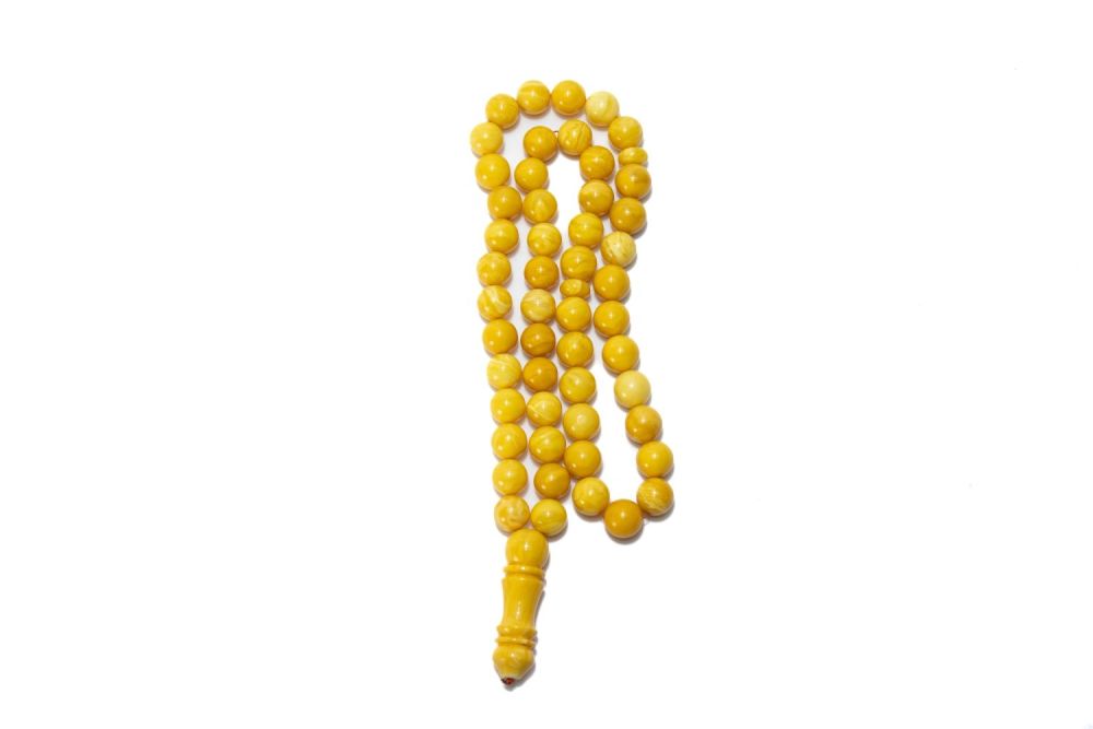 Lot 325: An Islamic Butterscotch Amber Prayer Beads.