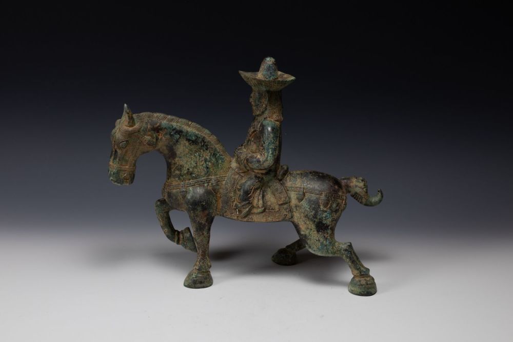 Lot 358: A Chinese Bronze Figure of a Man Riding...
