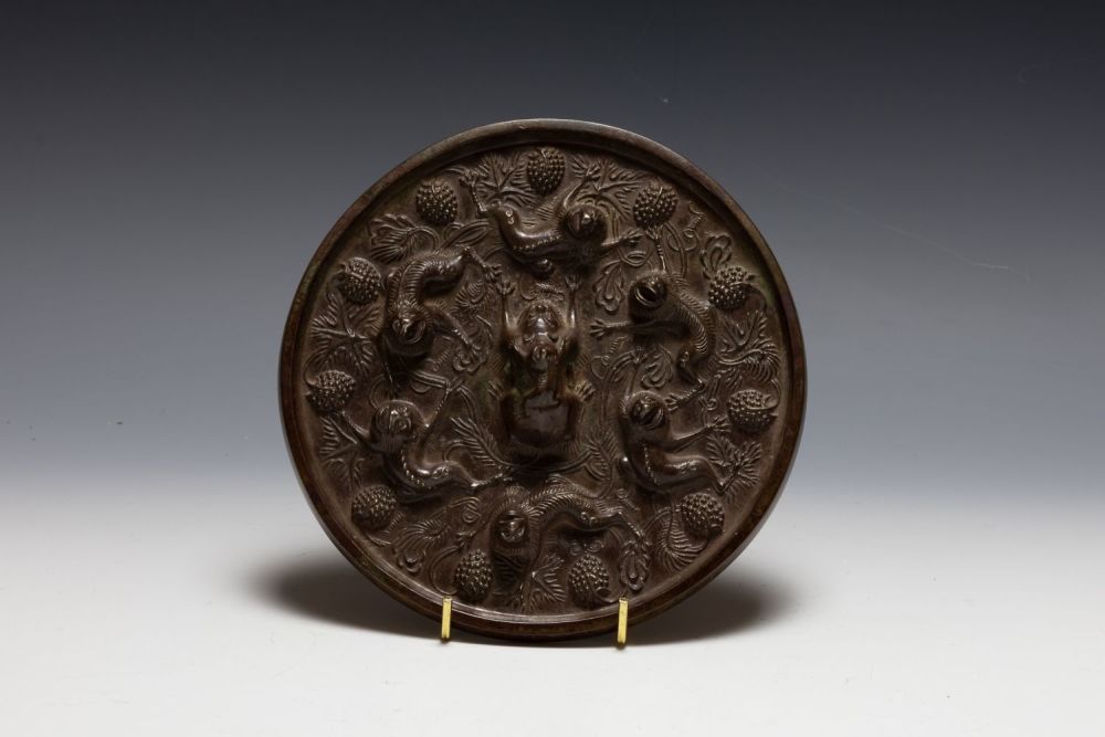 Lot 374: A Chinese Bronze Mirror Depicting Monkeys on the...