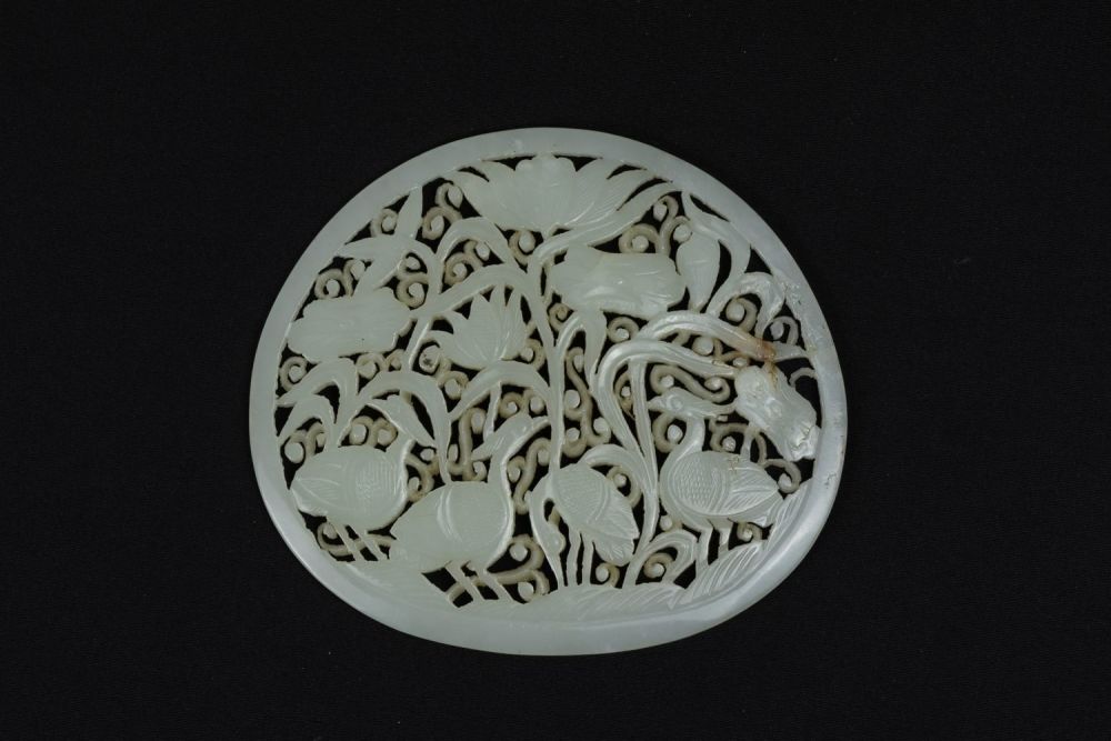 Lot 387: A Rare Large Chinese White Jade Circular Plaque...