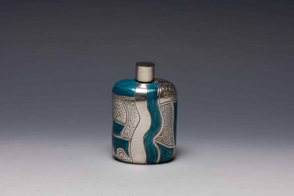 Lot 430: A Silver and Enamel Perfume Bottle by Enrico...