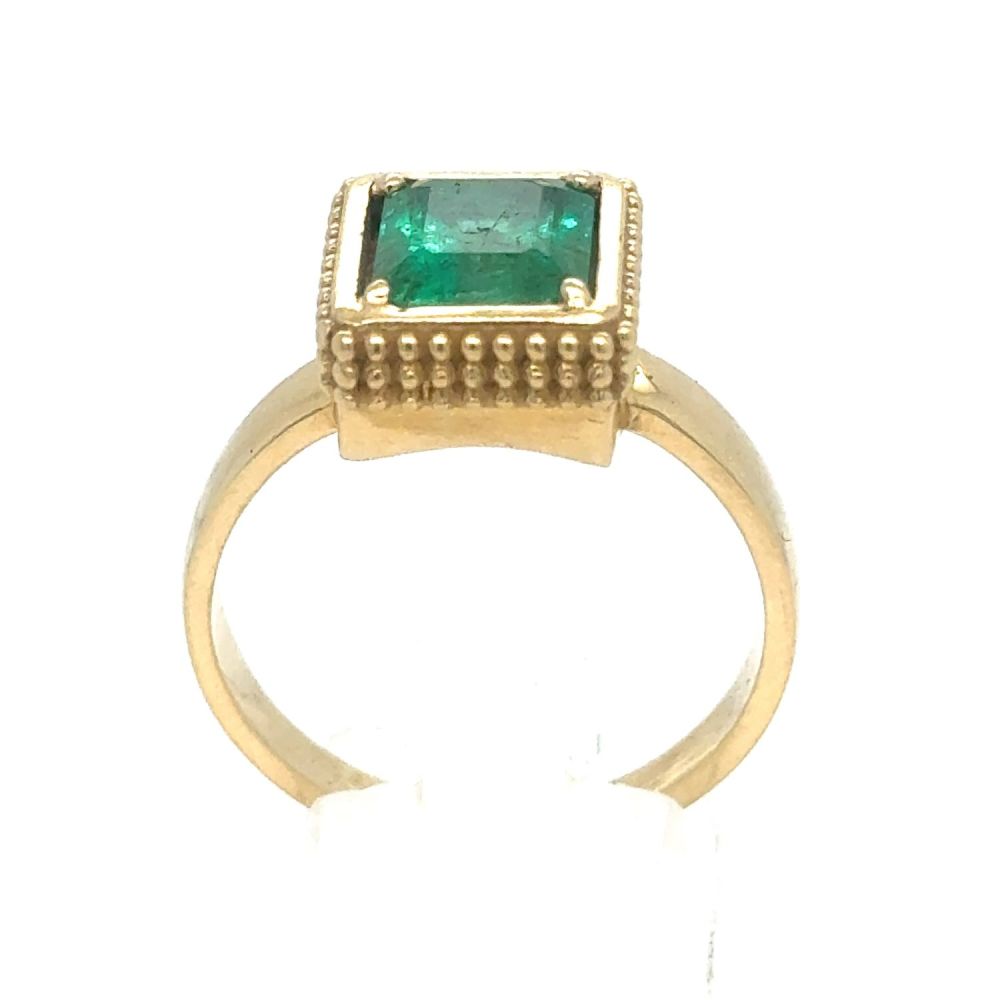 Lot 439: An Emerald Ring in Yellow Gold.