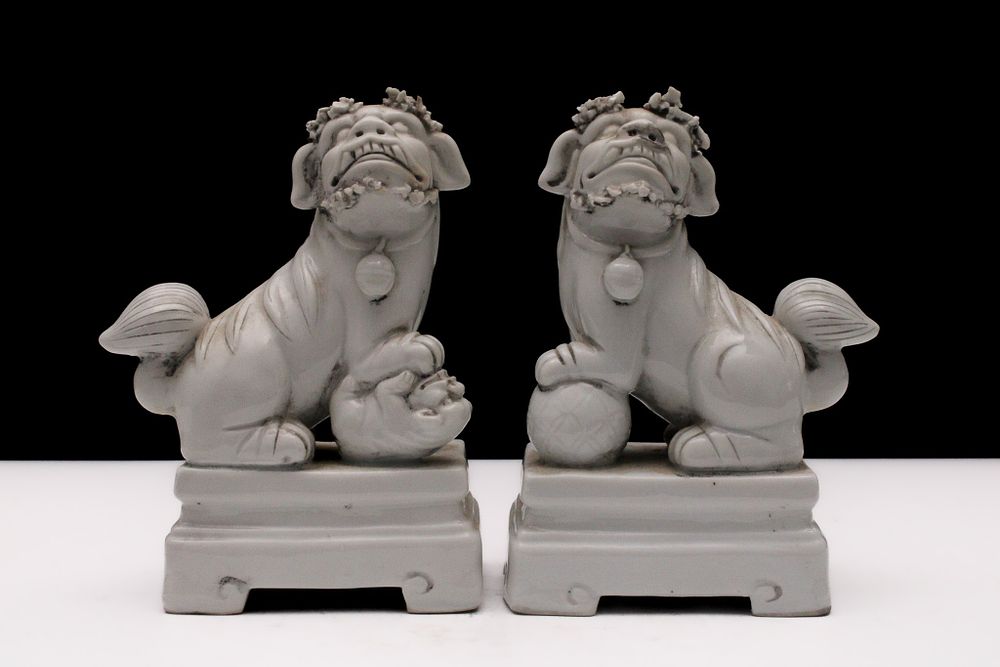 Lot 85: A Pair of Chinese Porcelain Figures of Dogs...