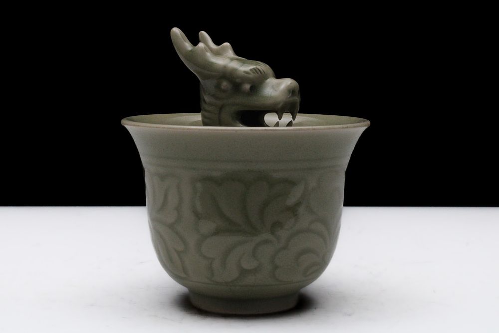 Lot 86: A Chinese Celadon Porcelain Vessel with a Dragon...