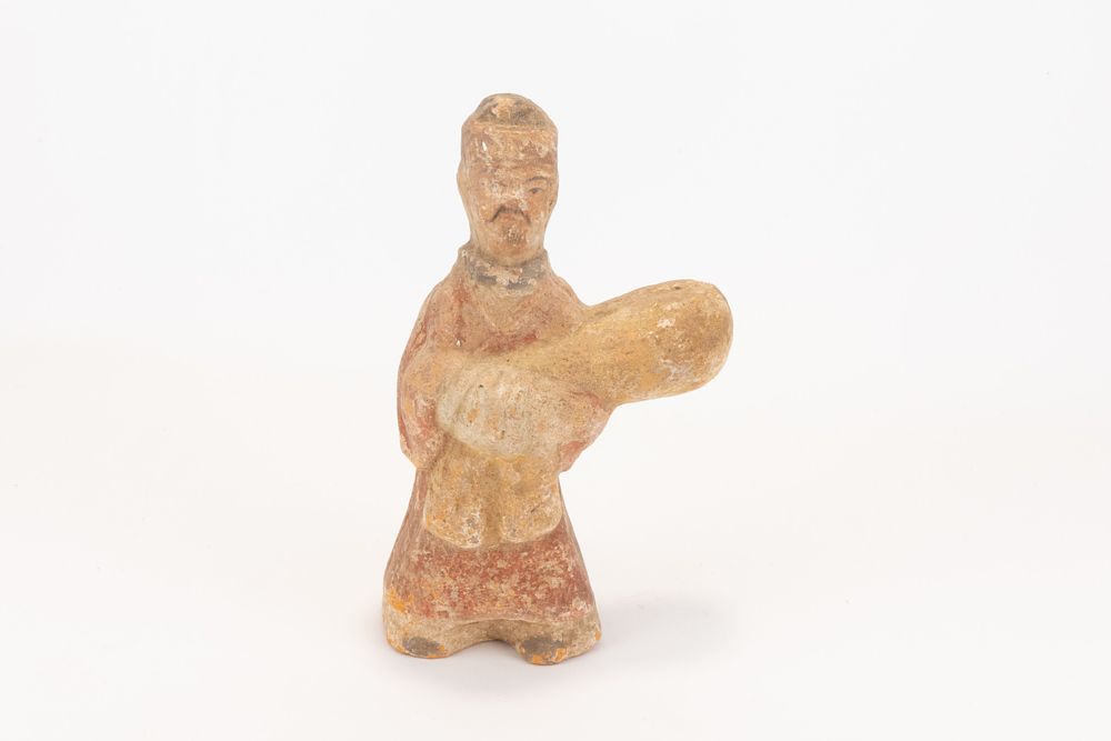 Lot 110: A Chinese Pottery Figure of a Standing Man...