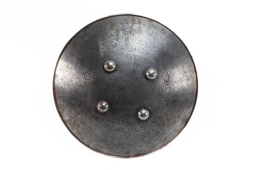 Lot 131: An Indian Steel Shield Decorated with Engraved Floral...