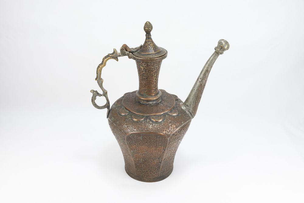 Lot 166: An Islamic Persian Copper Water Jug with Intricate...