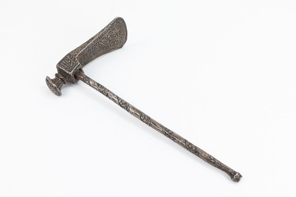 Lot 186: An Islamic Iron Axe with Intricate Islamic Calligraphy.