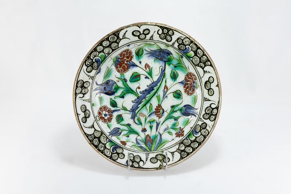 Lot 226: An Islamic Iznic Dish Depicting Multicoloured Floral Patterns...