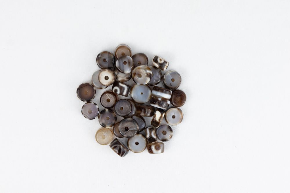 Lot 258: A Lot of 32 Tibetan Dzi Beads.